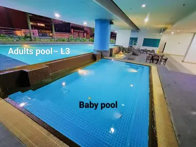 a swimming pool in a hotel with the words adults pool baby pool at Taragon Apartment - KL ,Malaysia in Kuala Lumpur