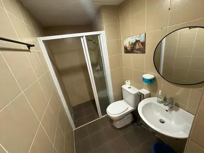 a bathroom with a toilet and a sink and a mirror at Taragon Apartment - KL ,Malaysia in Kuala Lumpur