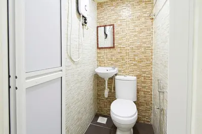 a bathroom with a toilet and a sink at Hotel 3Winz Chow Kit Kuala Lumpur in Kuala Lumpur