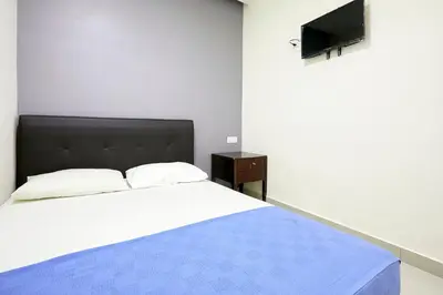 a bedroom with a bed and a flat screen tv at Hotel 3Winz Chow Kit Kuala Lumpur in Kuala Lumpur