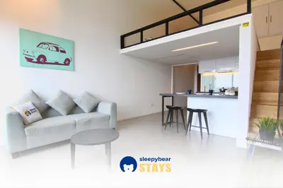 a living room with a couch and a table at Establishment Bangsar By Sleepy Bear in Kuala Lumpur