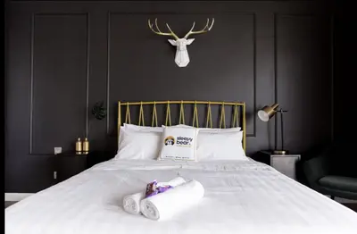 a bedroom with a bed with two rolls of toilet paper on it at Anggun Residence KLCC By Sleepy Bear in Kuala Lumpur
