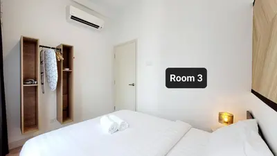 a white bedroom with a bed and a room three sign at Arte Plus By Sleepy Bear in Batu Empat