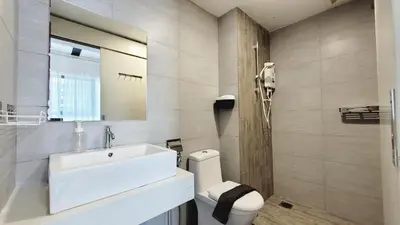 a bathroom with a white sink and a toilet at Arte Plus By Sleepy Bear in Batu Empat