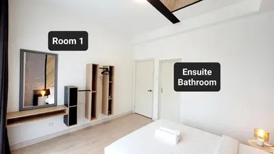 a white room with a bed and an exit sign at Arte Plus By Sleepy Bear in Batu Empat