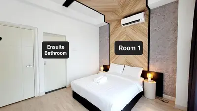 a bedroom with a white bed and a room with room at Arte Plus By Sleepy Bear in Batu Empat