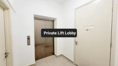 a hallway with aprivate lift lobby sign next to a door at Arte Plus By Sleepy Bear in Batu Empat