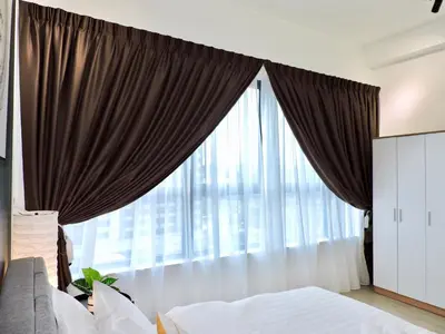 a bedroom with a large window with curtains at Arte Plus By Sleepy Bear in Batu Empat