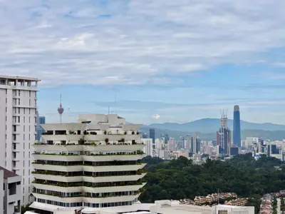 a view of a city skyline with a tall building at Ken Bangsar By Sleepy Bear in Kuala Lumpur