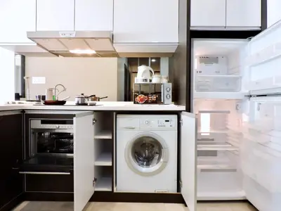 a kitchen with a washing machine and a washer at Ken Bangsar By Sleepy Bear in Kuala Lumpur