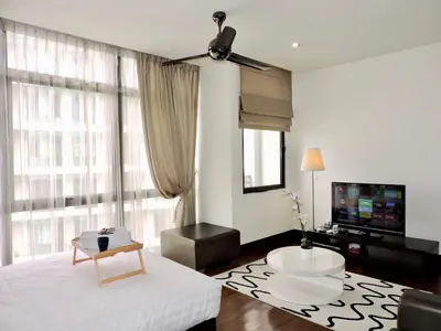 a white living room with a large window at Ken Bangsar By Sleepy Bear in Kuala Lumpur