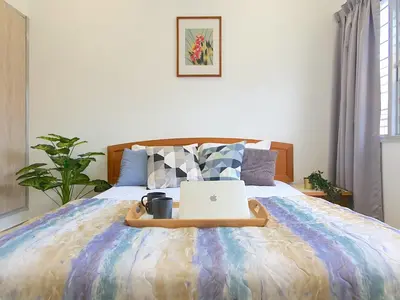a bed with a laptop on top of it at Kuala Lumpur Jalan Ipoh Terrace House in Kuala Lumpur