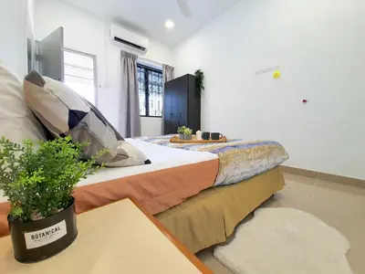 a bedroom with a large bed with a plant on it at Kuala Lumpur Jalan Ipoh Terrace House in Kuala Lumpur
