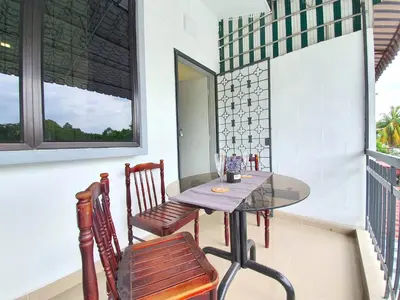 a table and chairs on a balcony with a window at Kuala Lumpur Jalan Ipoh Terrace House in Kuala Lumpur