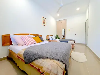 a bedroom with two beds with colorful pillows at Kuala Lumpur Jalan Ipoh Terrace House in Kuala Lumpur