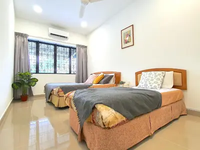two beds in a room with a window at Kuala Lumpur Jalan Ipoh Terrace House in Kuala Lumpur