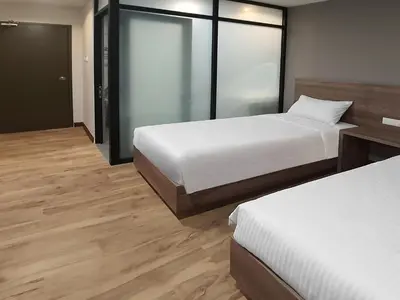 a hotel room with two beds and a sliding glass door at ACES Hotel Kuala Lumpur in Kuala Lumpur