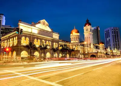 a building with a clock tower and a street at ACES Hotel Kuala Lumpur in Kuala Lumpur