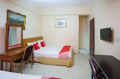 a bedroom with a bed and a desk and a television at Hotel O Perfect Class Hotel in Kuala Lumpur