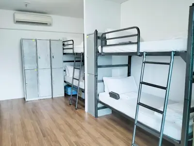 two bunk beds in a room with wooden floors at Valencia Dorm at Mercu Summer Suites KLCC in Kuala Lumpur