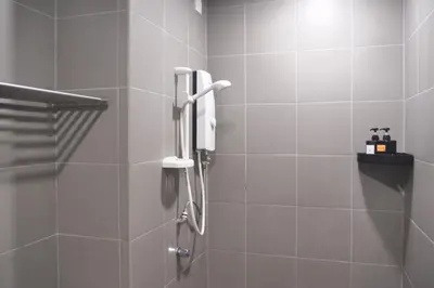 a shower with a phone in a bathroom at Valencia Dorm at Mercu Summer Suites KLCC in Kuala Lumpur