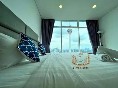 a hotel room with a large bed with a large window at Luxe Suites at Vortex KLCC in Kuala Lumpur