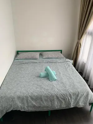 a blue teddy bear sitting on top of a bed at 2 bedroom apartment at 28 Boulavard in Kuala Lumpur