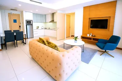 a living room with a couch and a table at Cormar Suites Kuala Lumpur in Kuala Lumpur