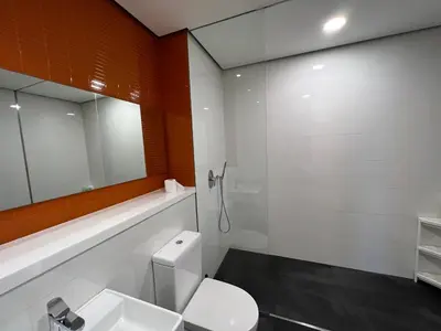 a bathroom with a white toilet and a mirror at ARCORIS, MONT KIARA by MK HOME in Kuala Lumpur