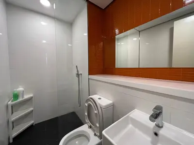 a bathroom with a toilet and a sink and a mirror at ARCORIS, MONT KIARA by MK HOME in Kuala Lumpur