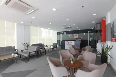 a waiting room with chairs and tables in an office at T-hotel Mont Kiara in Kuala Lumpur