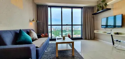 a living room with a blue couch and a large window at Infinity KLCC Pool at M City Ampang in Kuala Lumpur