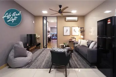 a living room with a couch and a tv at Lily and Loft - KL Gateway Bangsar LRT, WIFI, Netflix in Kuala Lumpur
