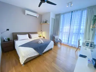 a bedroom with a bed and a large window at Lily and Loft - KL Gateway Bangsar LRT, WIFI, Netflix in Kuala Lumpur