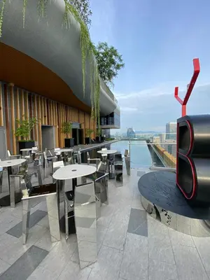 a restaurant with tables and chairs on a building at Ceylonz Seasonal Suites in Kuala Lumpur