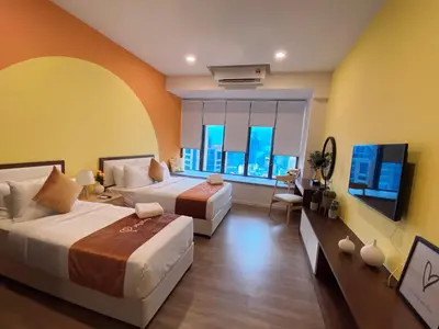 a bedroom with two beds and a large window at Ceylonz Starlight Suites Bukit Bintang in Kuala Lumpur