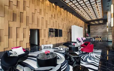 a lobby with chairs and tables in a room at Star Suites KLCC in Kuala Lumpur