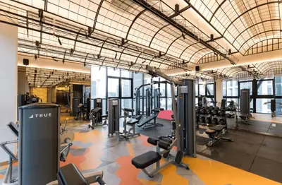 a gym with a lot of treadmills and machines at Scarletz Suites KLCC in Kuala Lumpur