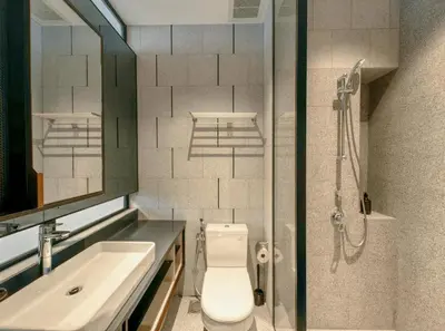 a bathroom with a toilet and a sink and a shower at Scarletz Suites KLCC in Kuala Lumpur