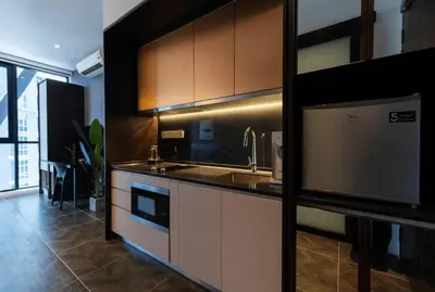 a kitchen with a sink and a stove at Scarletz Suites KLCC in Kuala Lumpur