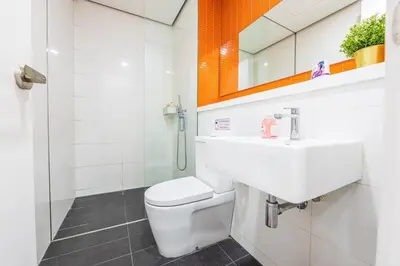 a bathroom with a toilet and a sink and a shower at Arcoris Mont Kiara in Kuala Lumpur