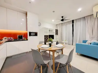 a kitchen and living room with a table and chairs at Arcoris Mont Kiara in Kuala Lumpur