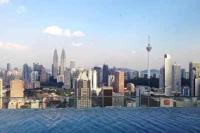 a view of a city skyline from the water at KLCC Regalia Suites Infinity Pool Kuala Lumpur in Kuala Lumpur
