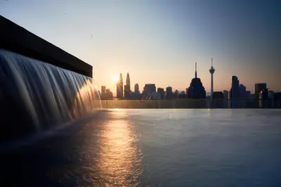 a view of a city skyline with a fountain at Regalia Suites Infinity Pool Kuala Lumpur in Kuala Lumpur