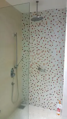 a shower with a glass door in a bathroom at Regalia Suites Infinity Pool Kuala Lumpur in Kuala Lumpur
