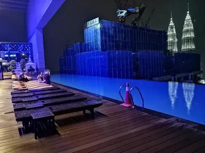 a stage with a pool with people sitting on benches at Yemala Suites at Platinum KLCC in Kuala Lumpur