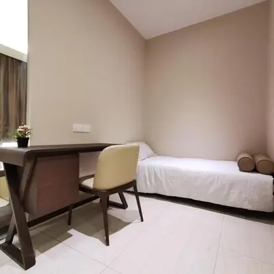 a bedroom with a desk and a bed and a chair at Dorsett Residences Kuala Lumpur in Kuala Lumpur