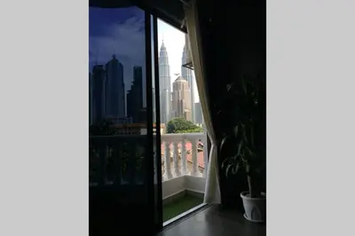 a balcony with a view of a city skyline at Omar's Place 2 in Kuala Lumpur