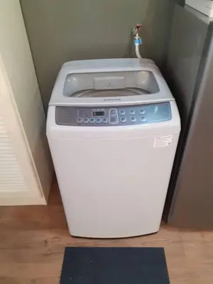 a washing machine in a corner of a room at Omar's Place 2 in Kuala Lumpur