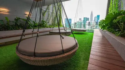 three swings on a balcony with a view of the city at Ceylonz Lifestyle Suites @ Bukit Bintang in Kuala Lumpur